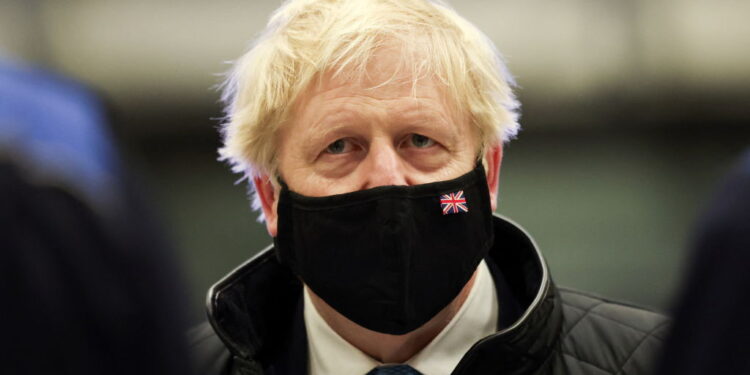 HOLYHEAD, UNITED KINGDOM - JANUARY 27:  Prime Minister Boris Johnson wears a face mask as he visits RAF Valley in Holyhead on January 27, 2022 in Anglesey, North Wales. The findings from Sue Gray's inquiry into several alleged lockdown rule-breaking parties at Downing Street, during the time when strict Covid-19 restrictions were in place, are expected to be published this week while Metropolitan Police announced on Tuesday it's conducting its own investigation into the alleged events.  (Photo by Carl Recine - WPA Pool/Getty Images)