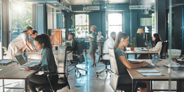 Corporate business people working in busy marketing office space, planning strategy in books and reading email on laptop at work. Businessman, businesswoman and workers at startup advertising company.