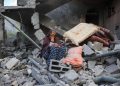 TOPSHOT - A woman cries while sitting on the rubble of her house, destroyed in an Israeli strike, in the Nuseirat refugee camp in central Gaza Strip on March 18, 2025. Israel on March 18 unleashed its most intense strikes on the Gaza Strip since a January ceasefire, with rescuers reporting 220 people killed, and Hamas accusing Benjamin Netanyahu of deciding to "resume war" after a deadlock on extending the truce. (Photo by Eyad BABA / AFP) (Photo by EYAD BABA/AFP via Getty Images)