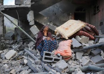 TOPSHOT - A woman cries while sitting on the rubble of her house, destroyed in an Israeli strike, in the Nuseirat refugee camp in central Gaza Strip on March 18, 2025. Israel on March 18 unleashed its most intense strikes on the Gaza Strip since a January ceasefire, with rescuers reporting 220 people killed, and Hamas accusing Benjamin Netanyahu of deciding to "resume war" after a deadlock on extending the truce. (Photo by Eyad BABA / AFP) (Photo by EYAD BABA/AFP via Getty Images)