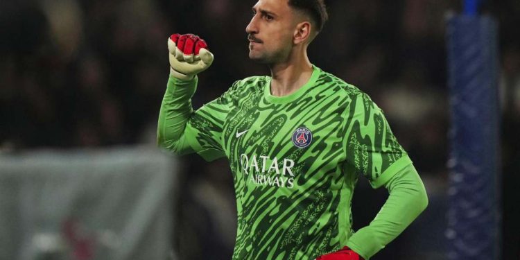 PSG's goalkeeper Gianluigi Donnarumma reacts after teammate Nuno Mendes scored their third goal during the Champions League quarterfinal first leg soccer match between Paris Saint-Germain and Aston Villa at Parc des Princes stadium in Paris, Wednesday, April 9, 2025. (AP Photo/Aurelien Morissard)