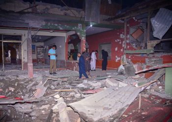 Local residents and members of the media examine a building damaged by a suspected Indian missile attack near Muzaffarabad, the capital of Pakistan controlled Kashmir, in Wednesday, May 7, 2025. (AP Photo/M.D. Mughal)