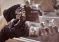 Close-up of the seller's hands in gloves shows the exclusive men's watch from the new collection