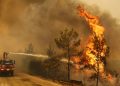 A firefighter extinguishes a forest fire near the town of Manavgat, east of the resort city of Antalya, Turkey, July 30, 2021. REUTERS/Kaan Soyturk