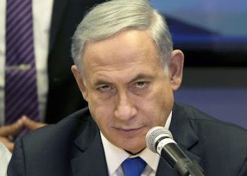 FILE - In a Monday, March 16, 2015 file photo, Israeli Prime Minister Benjamin Netanyahu attends a Likud party meeting in Or Yehuda near Tel Aviv, Israel, a day ahead of legislative elections. Israel's election has yielded a fractured parliament and no clear winner, setting up a horse-trading phase that seems likely to leave Netanyahu in his post and place the country on the brink of confrontation with the world. It could also force a joint government with moderate challenger Isaac Herzog. And there is the slimmest of chances that Herzog, through machinations, ends up on top.  Everything is in the hands of Moshe Kahlon, a relative newcomer to the big leagues of Israeli politics.  (AP Photo/Ariel Schalit, File)