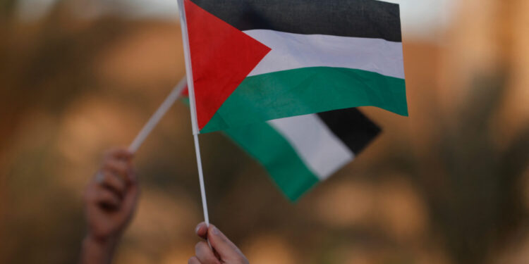 Iraqis raise the Palestinian flag during a rally in solidarity with Palestinians and in condemnation of Israel and the US in Baghdad on September 23, 2025. (Photo by AHMAD AL-RUBAYE / AFP) (Photo by AHMAD AL-RUBAYE/AFP via Getty Images)