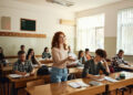 Teenage high school student talking during an oral exam in the classroom.