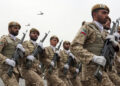 In this photo released by the official website of the office of the Iranian Presidency, troops march during the army parade commemorating National Army Day in front of the shrine of the late revolutionary founder Ayatollah Khomeini, just outside Tehran, Iran, Thursday, April 18, 2019. Iran showcased its domestically made fighter jets by flying the aircraft over Tehran during the parade Thursday as the country grapples with U.S. sanctions and the Trump administration's recent terrorism designation of Iran's powerful paramilitary force. (Iranian Presidency Office via AP)