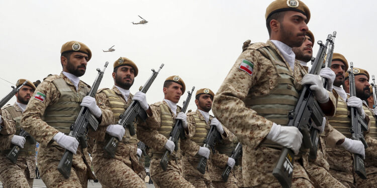 In this photo released by the official website of the office of the Iranian Presidency, troops march during the army parade commemorating National Army Day in front of the shrine of the late revolutionary founder Ayatollah Khomeini, just outside Tehran, Iran, Thursday, April 18, 2019. Iran showcased its domestically made fighter jets by flying the aircraft over Tehran during the parade Thursday as the country grapples with U.S. sanctions and the Trump administration's recent terrorism designation of Iran's powerful paramilitary force. (Iranian Presidency Office via AP)